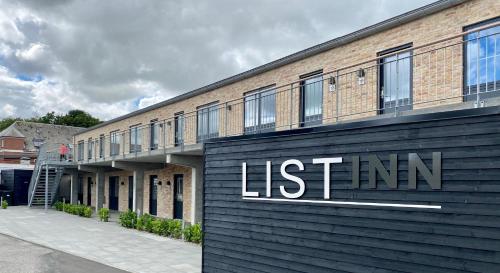a brick building with a sign on the side of it at List Inn in Brande