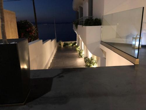 a view of a balcony of a house at night at Nautilus Nontas Hotel in Megalochori