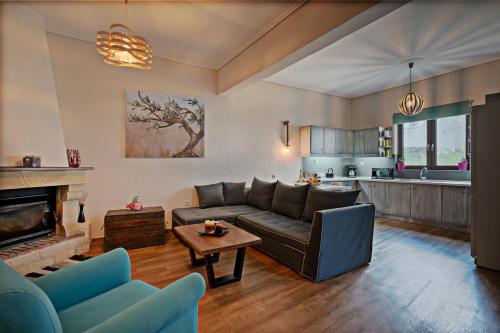 a living room with a couch and a fireplace at Casa Sofia, By Hellocrete in Spílion