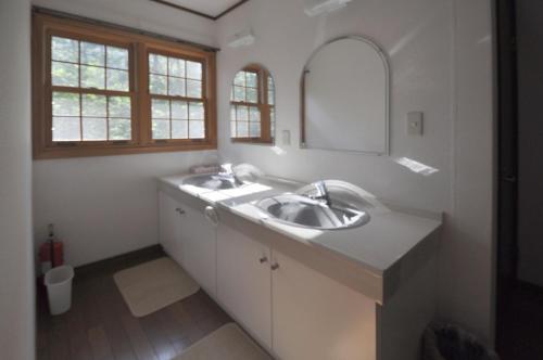 a bathroom with a sink and a mirror at Creek House Hakuba - Vacation STAY 87290 in Hakuba