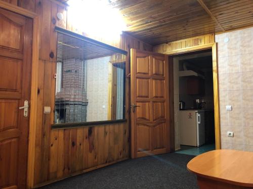 a room with a wooden door and a window at Apartment complex in Sumy