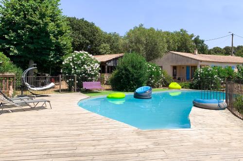 
a pool with a surfboard in the middle of it at B&B Arghjola in Porto-Vecchio
