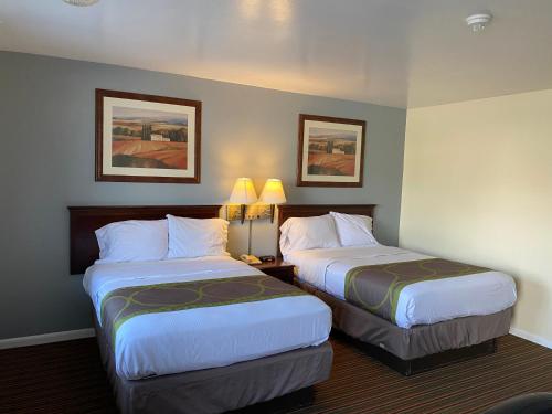 a hotel room with two beds and two lamps at Relax Inn in Brunswick