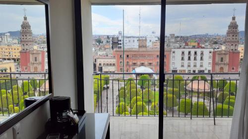 um quarto com vista para a cidade a partir de uma janela em Ramada Plaza by Wyndham Leon em León