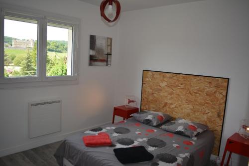 a bedroom with a bed and a window at Gîte La Cabotte Rullyotine in Rully