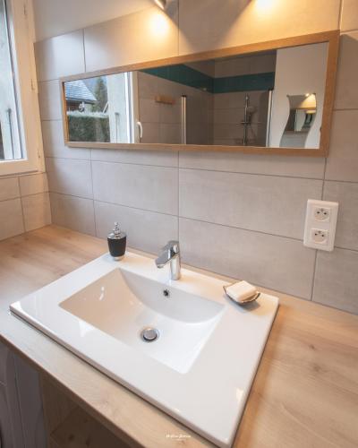 a bathroom with a white sink and a mirror at Maison individuelle "Gite la Soulane" à 2 min de Saint lary soulan in Vielle-Aure