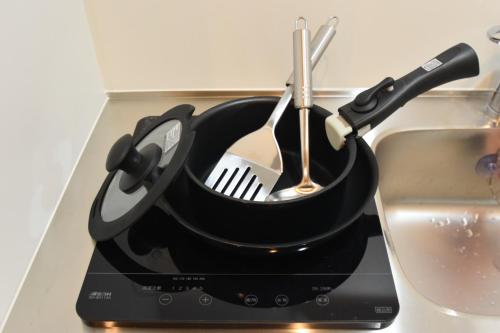 a pot with utensils in it next to a sink at REGALO Shibaura - Vacation STAY 88351 in Tokyo