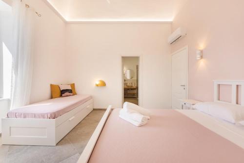 two beds in a room with white walls at Villa Caterina b&b in Procida