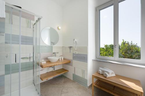 a bathroom with a sink and a glass shower at Villa Caterina b&b in Procida