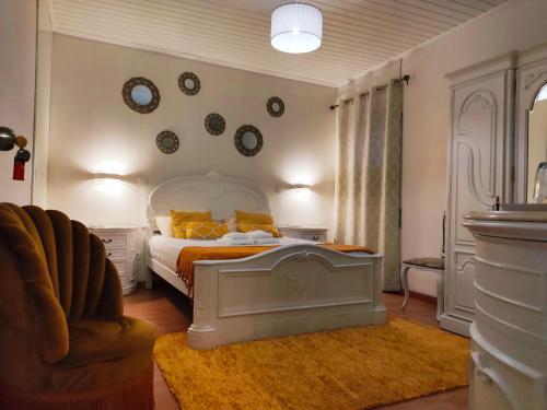 a bedroom with a bed with an orange and white bedspread at Santo Cristo House in Ponta Delgada