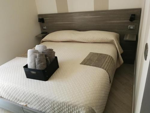 Una cama con una caja de toallas. en Happy Family B&B en Viggianello