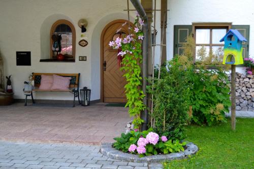 a front door of a house with flowers at Gästehaus Willfert in Reit im Winkl