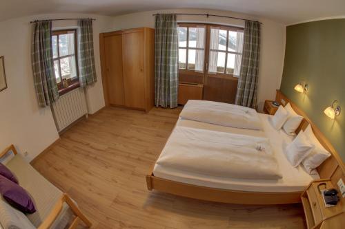 a bedroom with a large bed in a room at Gästehaus Willfert in Reit im Winkl