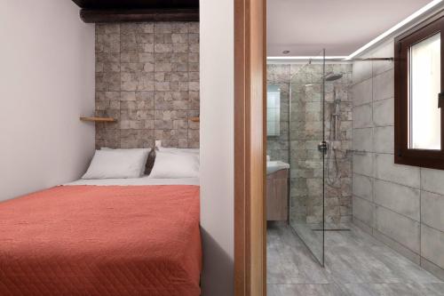 a bedroom with a bed and a glass shower at Apartments in the center marasia in Rhodes Town