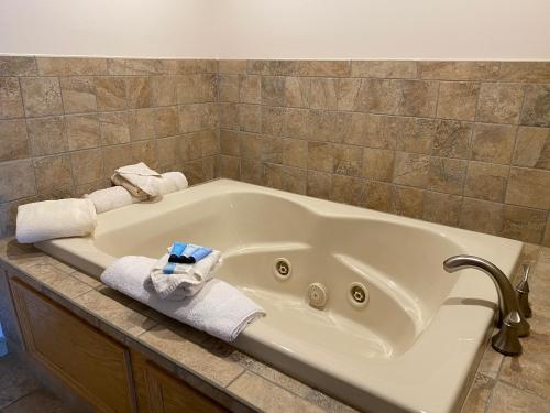 a white bath tub with towels on top of it at The Georgian Resort in Lake George