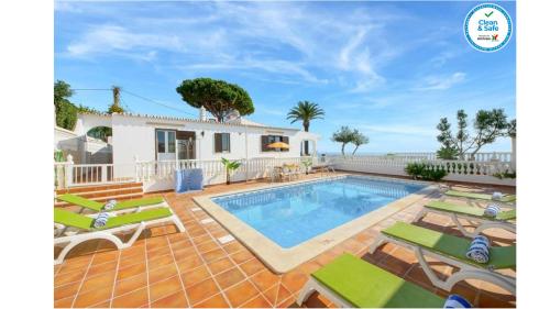 a villa with a swimming pool and a house at Villa Brigida in Albufeira