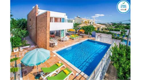 an aerial view of a house with a swimming pool at Villa Oceano in Albufeira
