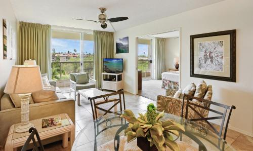 a living room with a couch and a table at Castle at Maui Banyan in Wailea