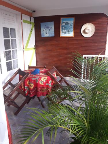 a table and chairs on a porch with plants at LE VILLAGE DE CANADA in Faup