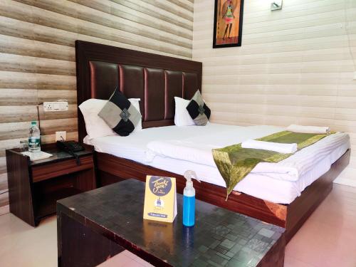 a bedroom with a bed and a table with a book at Cloud 7 in Nainital