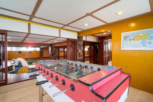 a large ping pong table in a room with a pool at Angel Pool Villa Phuket - SHA Extra Plus in Phuket Town