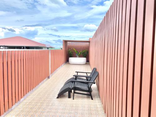 a pair of benches sitting on a fence at Behind The Scene Hotel Club @ Samui in Chaweng