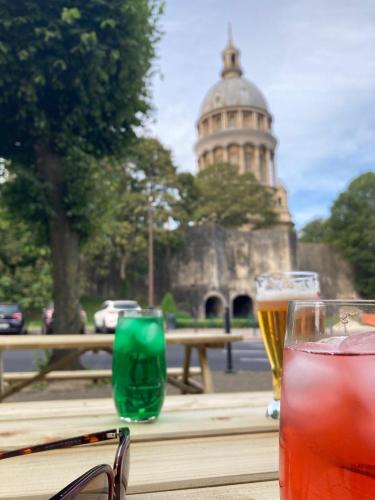 two glasses of beer sitting on a table in front of a building at ibis Styles Boulogne sur Mer Centre Cathédrale in Boulogne-sur-Mer