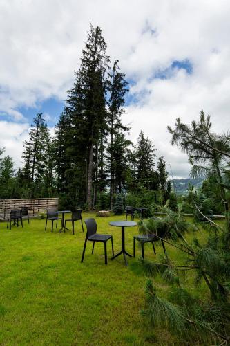 a group of tables and chairs in a field at Green Deer Premium in Zakopane