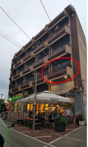 a red circle on the side of a building at Ioannina In - central & modern apt 36m2 lake view in Ioannina