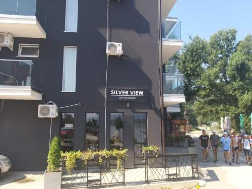 a black building with a silver way sign on it at Apartman Nikolic in Veliko Gradište