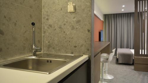 a bathroom with a stainless steel sink in a room at eleven views resort in Ilia