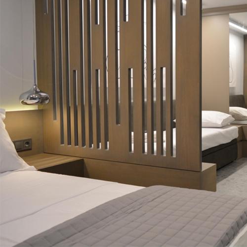 a bedroom with two beds and a large headboard at eleven views resort in Ilia