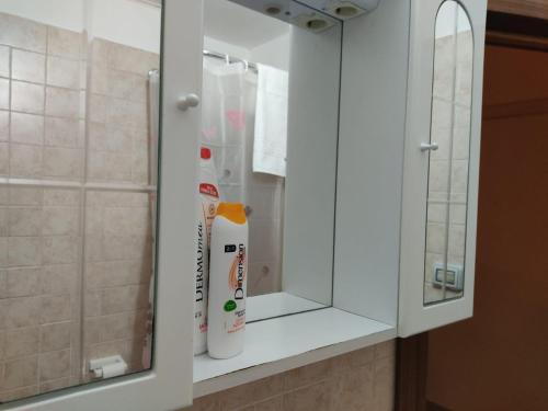 a white cabinet with a mirror in a bathroom at Casa Vacanza Villa Teresa - Appartamento Girasole in Torre Lapillo
