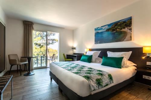 Postel nebo postele na pokoji v ubytování Hôtel Corniche du Liouquet