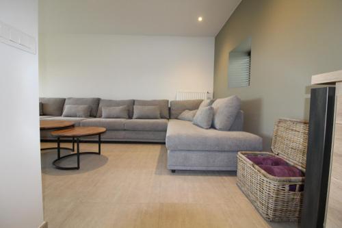 a living room with a couch and a table at De Ast by De Oude Kaasmakerij in Passendale