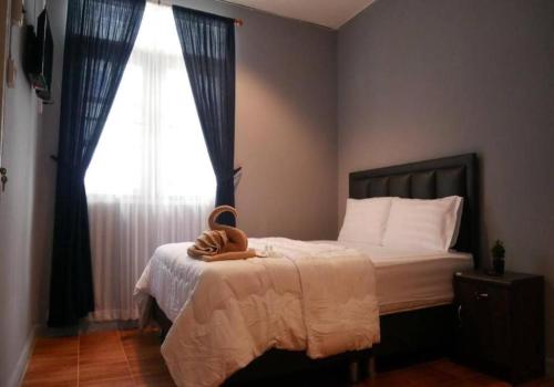 a bedroom with a bed with a large window at airport house in Bangkok