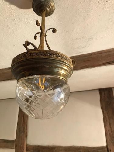 aendant light hanging from the ceiling of a room at Pfarrhof Stuer in Stuer