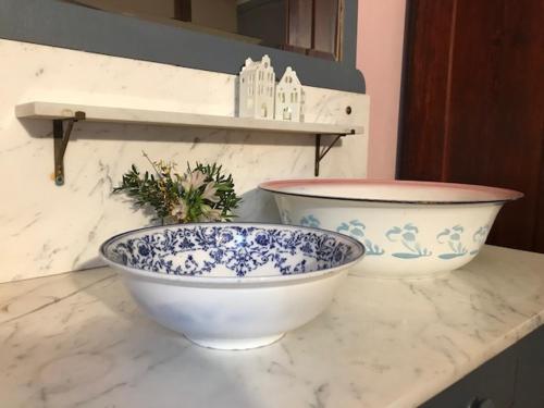 two blue and white bowls sitting on a counter at Pfarrhof Stuer in Stuer