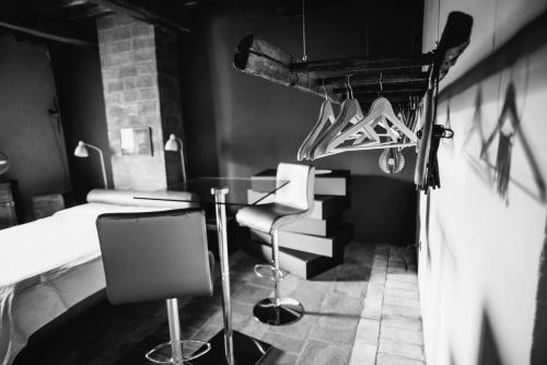 a room with a table and some hangers and shoes at Morelliana4Rooms in Scansano