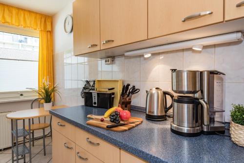 a kitchen with a counter top with fruits and appliances at Ferienwohnungen Störtebeker in Zempin
