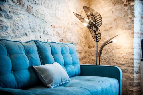 a living room with a blue couch and blue pillows at Apartments Casa De Amicis in Rovinj
