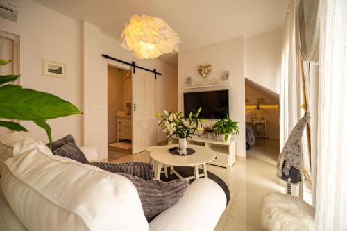 a living room with a white couch and a table at Apartamenty Ceglana 1 A in Zielona Góra