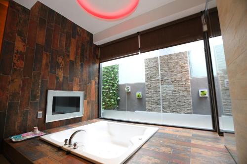 a bathroom with a large sink and a large window at Yosemite Motel - Chunghua Branch in Taichung