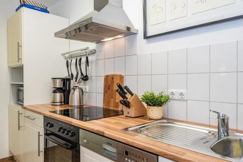 a kitchen with a sink and a stove top oven at Ferienwohnungen Störtebeker in Zempin