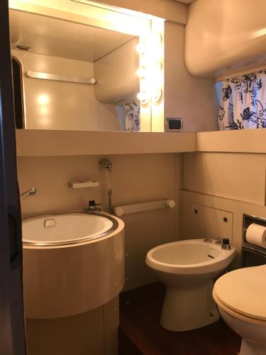 a small bathroom with a sink and a toilet at Sea BaronIV "BedsonBoat" in Birgu