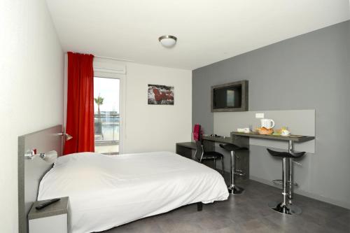 Ένα ή περισσότερα κρεβάτια σε δωμάτιο στο Vacancéole - Le Terral - Montpellier Sud