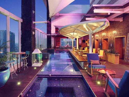 a hotel with a swimming pool on a building at Mercure Jakarta Simatupang in Jakarta