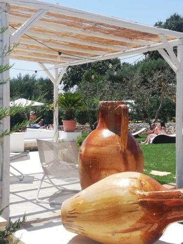 a large brown vase sitting under a pavilion at Dimora San Quirico - bed e breakfast - Cisternino in Cisternino