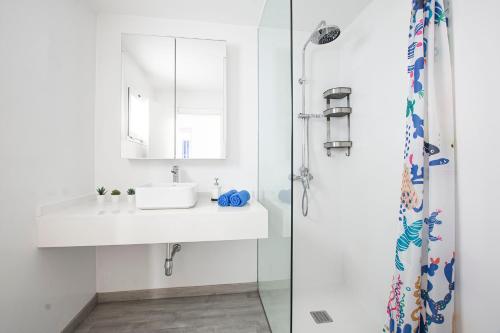 a bathroom with a sink and a shower at Lanzahost Tabayba Sun in Costa Teguise