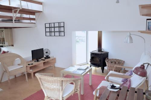 a living room with a wood stove in it at Quinta da Falesia - Casa Branca in Ponta Delgada